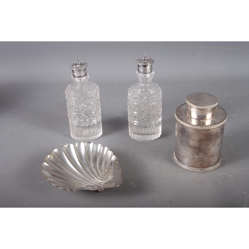 318 - A silver scallop shaped butter dish, 2oz troy approx, a silver plated tea caddy and two cut glass co... 