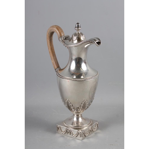 322 - An 18th century silver pedestal hot water jug with acorn finial, acanthus and laurel leaf decoration... 