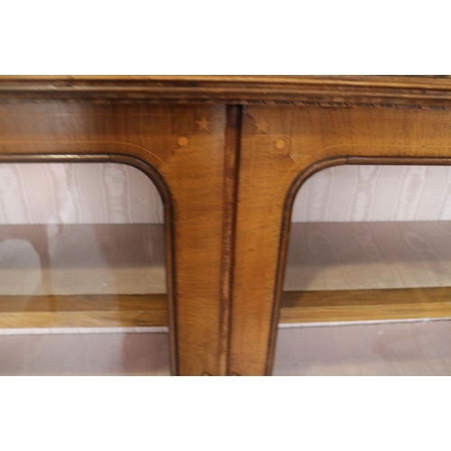 406 - A Victorian figured walnut gilt metal mounted low bookcase enclosed two glazed arch top doors, on bl... 