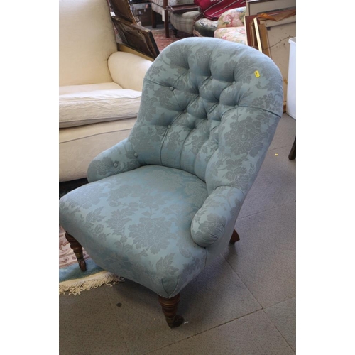 407 - A late 19th century low seat tub chair, button upholstered in a blue brocade, on turned and castored... 