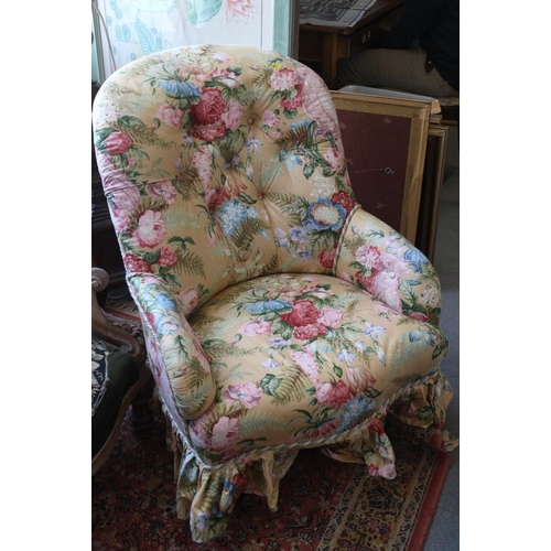 409 - A late Victorian tub shape armchair, button upholstered in a floral chintz on an ochre ground