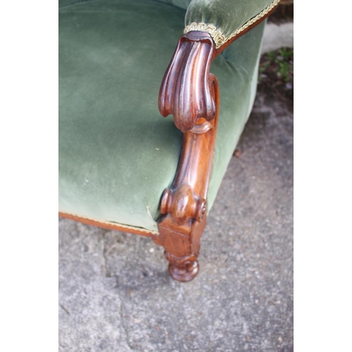 428 - A Victorian mahogany open armchair, button upholstered in a green velour, on turned and carved suppo... 