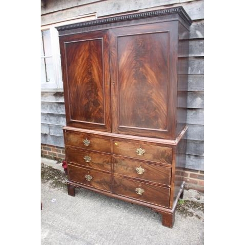 435 - A late Georgian figured mahogany linen press, the upper section enclosed two doors over two short an... 