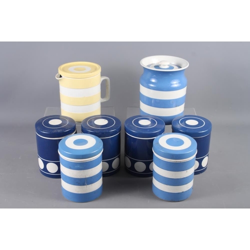 44 - Seven Cornishware blue and white storage jars, and a yellow and white Cornishware jug and cover, 6