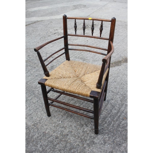 462 - A late 19th century Sussex elbow chair with rush envelope seat, on turned and stretchered supports