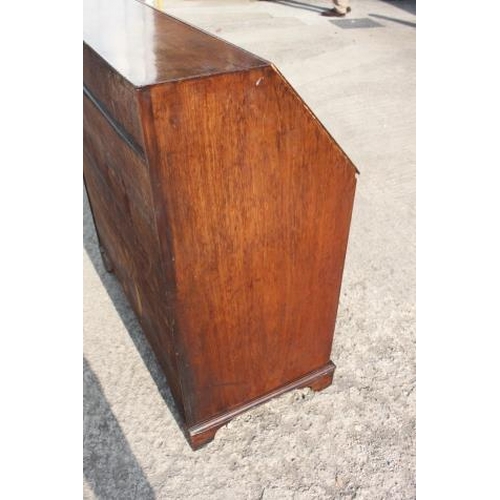 468 - A late Georgian mahogany fall front bureau, the fitted interior over four long graduated drawers wit... 