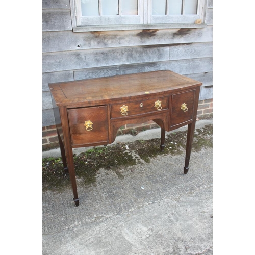 475 - An early 19th century mahogany, banded and ebony line inlaid bowfront sideboard, fitted one shallow ... 