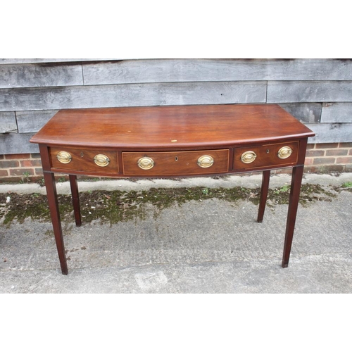 485 - A George III mahogany bowfront side table, fitted three drawers with brass oval handles, on square t... 