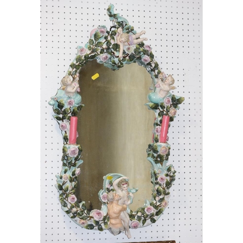 512 - An early 20th century Dresden porcelain framed wall mirror, decorated roses, cherubs and merman, wit... 