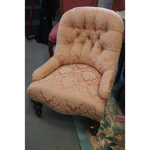 515 - A tub shape occasional chair, button upholstered in a floral pink brocade, on turned supports