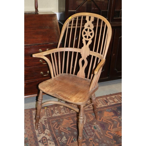 523 - An ash and elm Windsor splat back elbow chair with panel seat and crinoline stretcher