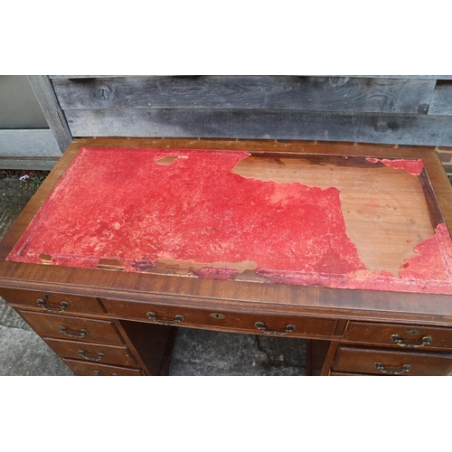 531 - A walnut twin pedestal desk with nine drawers, on bracket supports and tooled red leather top (losse... 