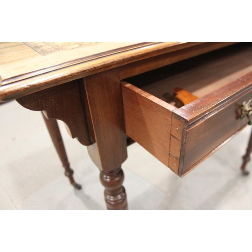 553 - An Edwardian walnut writing desk with tooled lined top, fitted one drawer, on turned and castored su... 