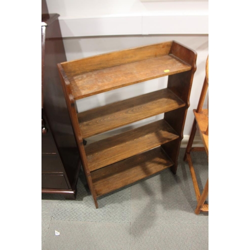 555 - A 1920s low open bookcase, fitted four shelves, on panel end supports, 24