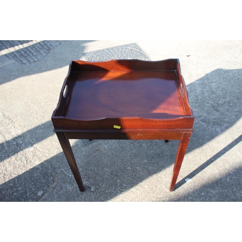 580 - A mahogany tray top stand, on square taper supports, 20