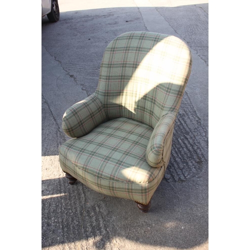 589 - A tub seat armchair, upholstered in a tartan fabric, on turned supports