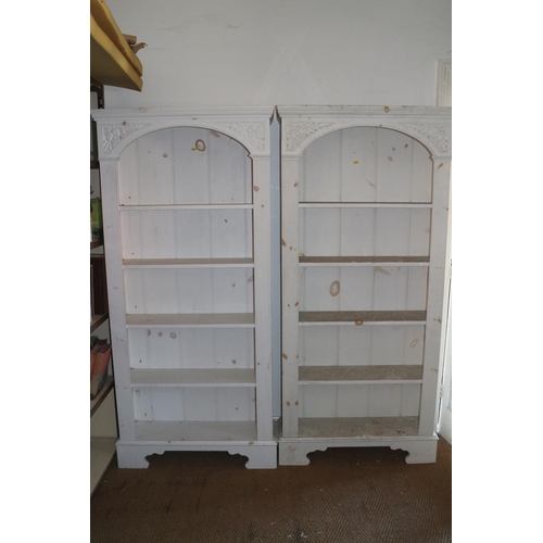 599 - A pair of white painted carved pine open bookcases with reeded sides, on bracket feet, 33 1/2