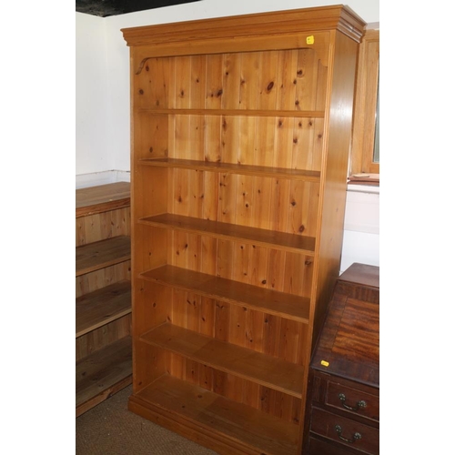 602 - A pine open bookcase, fitted six shelves, on block base, 38