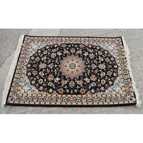 608 - A fine woven full pile rug with Sharbas medallion design on a black ground, 56