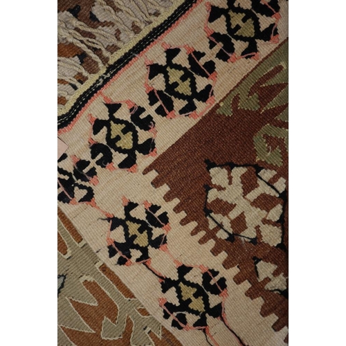 615 - A Kazak kelim rug with two hooked guls on a tan ground, 50