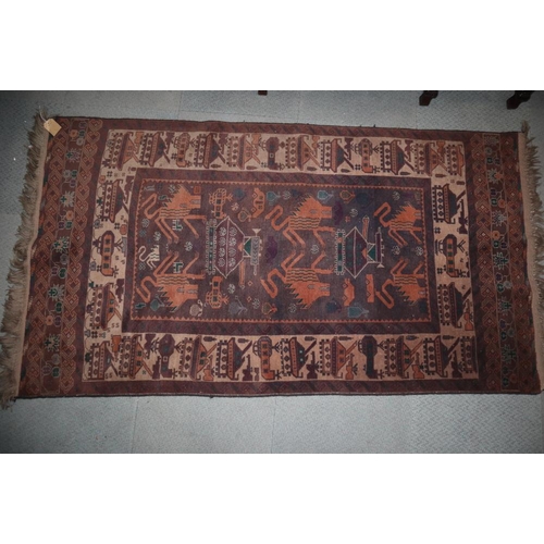 620 - An Afghan rug with lion and Russian tank design on a plum ground, 79