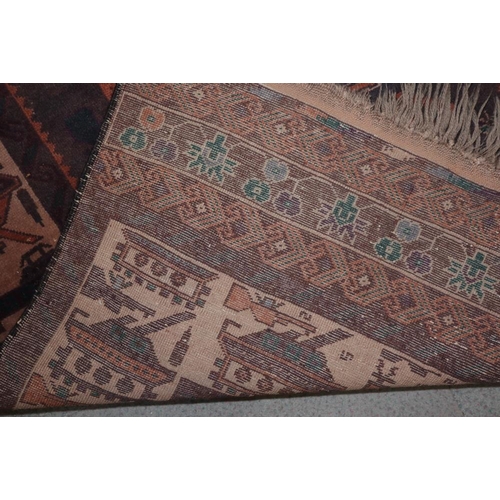 620 - An Afghan rug with lion and Russian tank design on a plum ground, 79