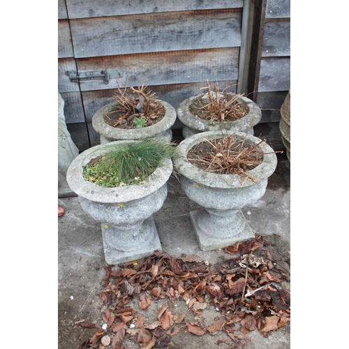 622 - A set of four cast stone planters, on square bases, 15 1/2