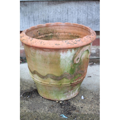 627 - A terracotta plant pot with undulated decoration and relief handles, 13 3/4