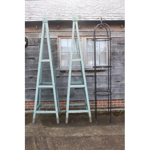 630 - A pair of green painted garden obelisks, 104