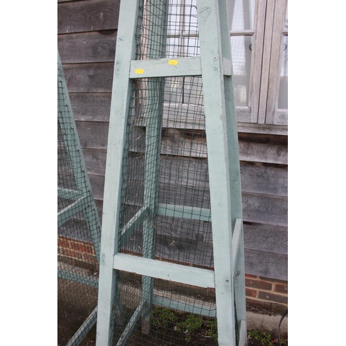 630 - A pair of green painted garden obelisks, 104