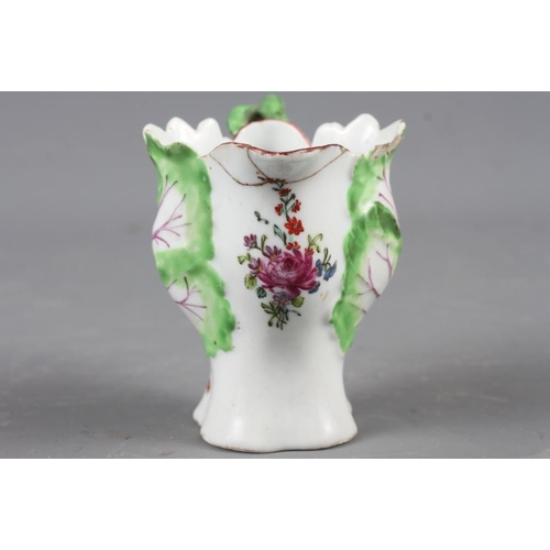 7 - A Longton Hall cream jug with openwork twist handle and leaf relief decoration and enamel floral spr... 