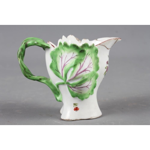 7 - A Longton Hall cream jug with openwork twist handle and leaf relief decoration and enamel floral spr... 