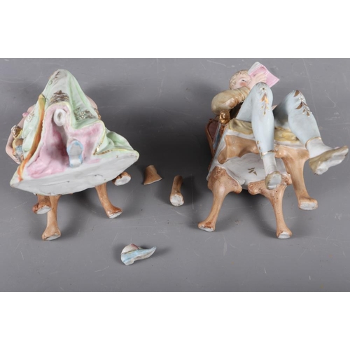 78 - A pair of Continental bisque seated figures, 6 3/4