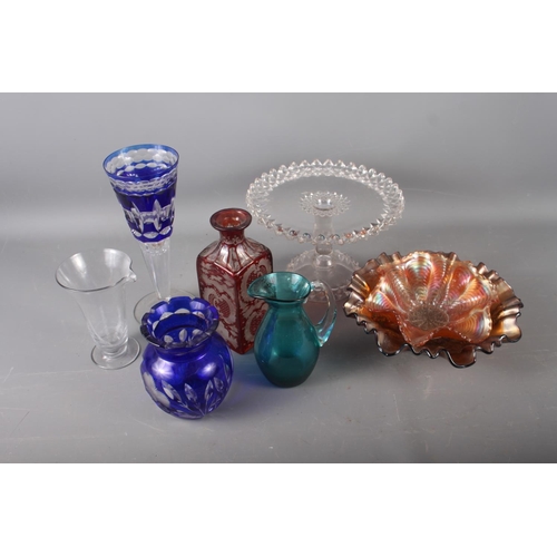 84 - A Bohemian red and clear cut glass decanter, a blue and clear cut glass goblet, 9