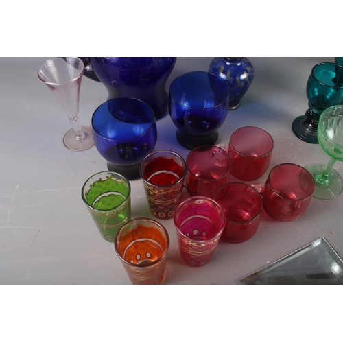 98 - A quantity of coloured glassware, including retro wines, cranberry glass mugs, a gilt decorated dish... 