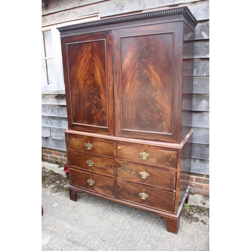 435 - A late Georgian figured mahogany linen press, the upper section enclosed two doors over two short an... 