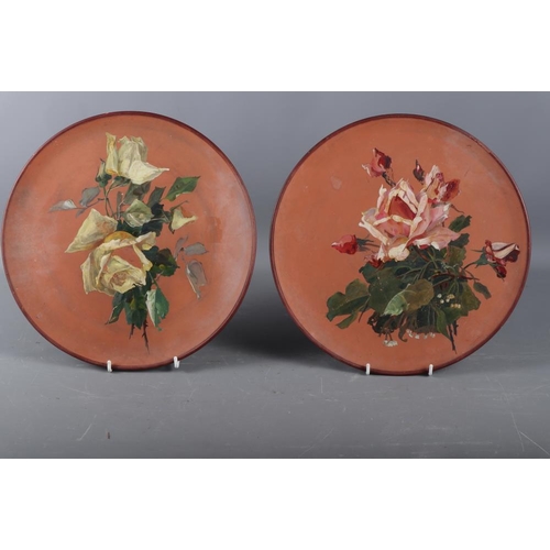 80 - A pair of Watcombe terracotta plates, decorated roses, 12 1/2