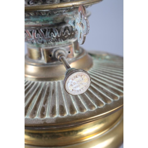 262 - A brass oil lamp with embossed decoration, on a square base, 21