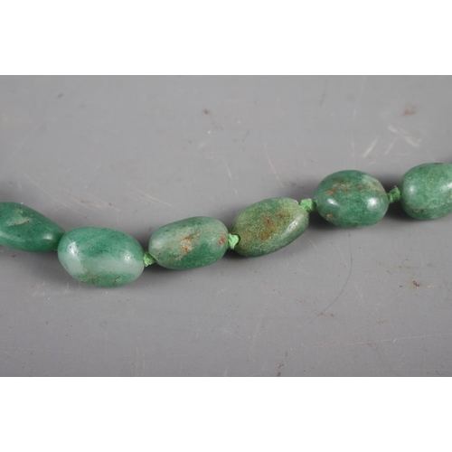 327 - A jadeite graduated pebble bead necklace, 36