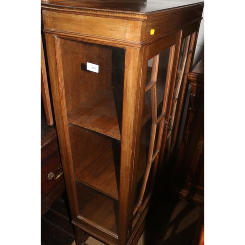 568 - An oak ledge back display cabinet, enclosed lattice glazed doors, on turned and stretchered supports... 