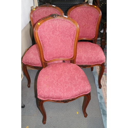 574 - Three walnut framed salon chairs, upholstered in a pink brocade, on cabriole supports, a spoon back ... 