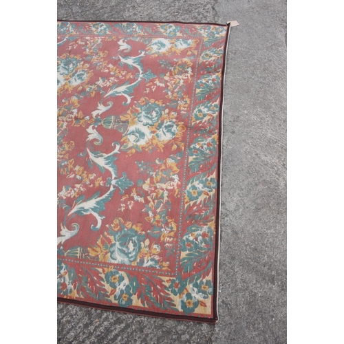 612 - A Jacquard woven floor carpet of 18th century design with floral scroll design, 100