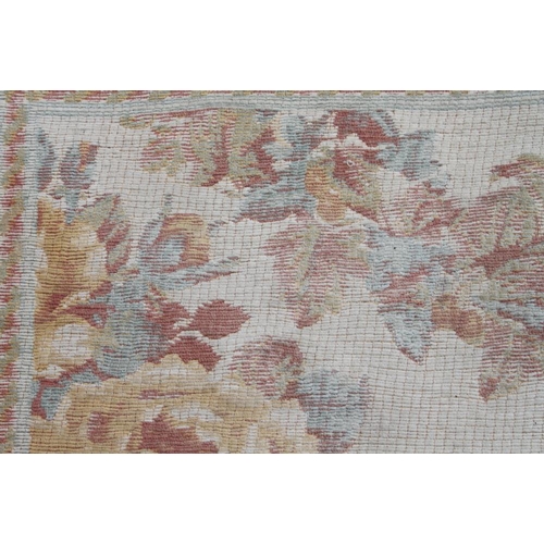 612 - A Jacquard woven floor carpet of 18th century design with floral scroll design, 100