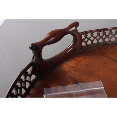 171 - A late 19th century figured mahogany two-handled tray with pierced gallery, 29