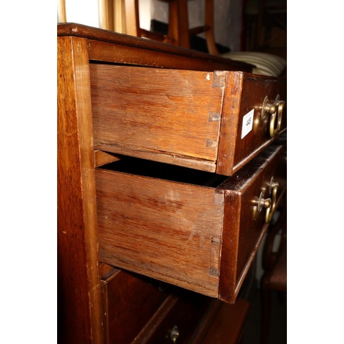 448 - A late Georgian mahogany chest of four long graduated drawers with brass bail handles, on bracket fe... 