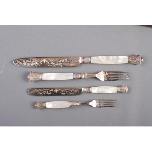 302 - A set of twelve silver plated and engraved dessert knives and forks and matching servers, with mothe... 