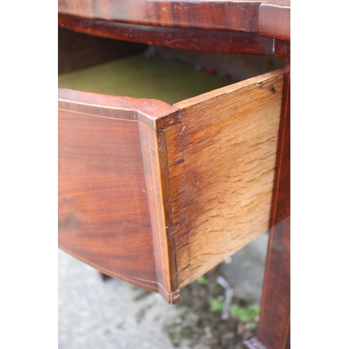 469 - An early 19th century mahogany and rosewood banded serpentine front sideboard, fitted cellarette dra... 