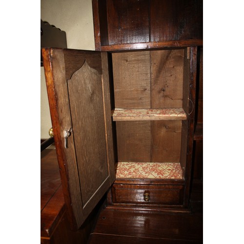 413 - An oak dresser, the upper section fitted two open shelves, two cupboards and two drawers, over three... 