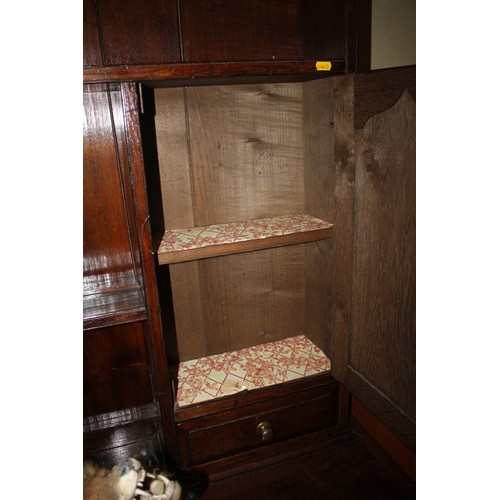 413 - An oak dresser, the upper section fitted two open shelves, two cupboards and two drawers, over three... 