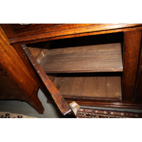 413 - An oak dresser, the upper section fitted two open shelves, two cupboards and two drawers, over three... 